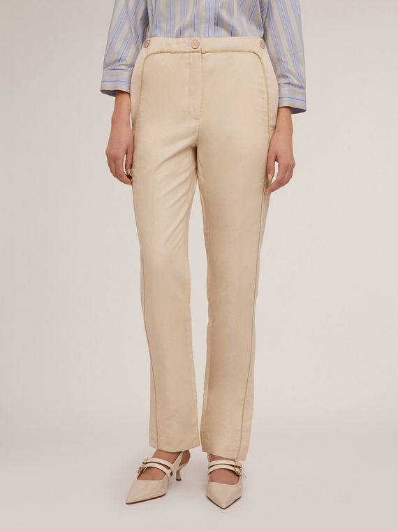 Trousers with piping and slit at the hem